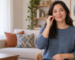 Woman demonstrating the ASL sign for home by touching a flattened O handshape to her cheek